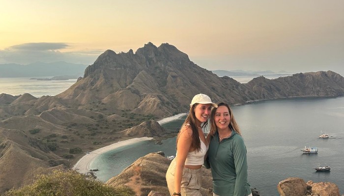 A shared luxury boat with travelers snorkeling and relaxing in the waters of Komodo National Park.